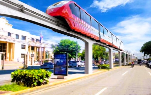 Santiago de Los Cabelleros 800.000 EW. Monoreal ab 2026 Monorail verläuft über eine Straße mit modernen Gebäuden und Bäumen im Hintergrund.
